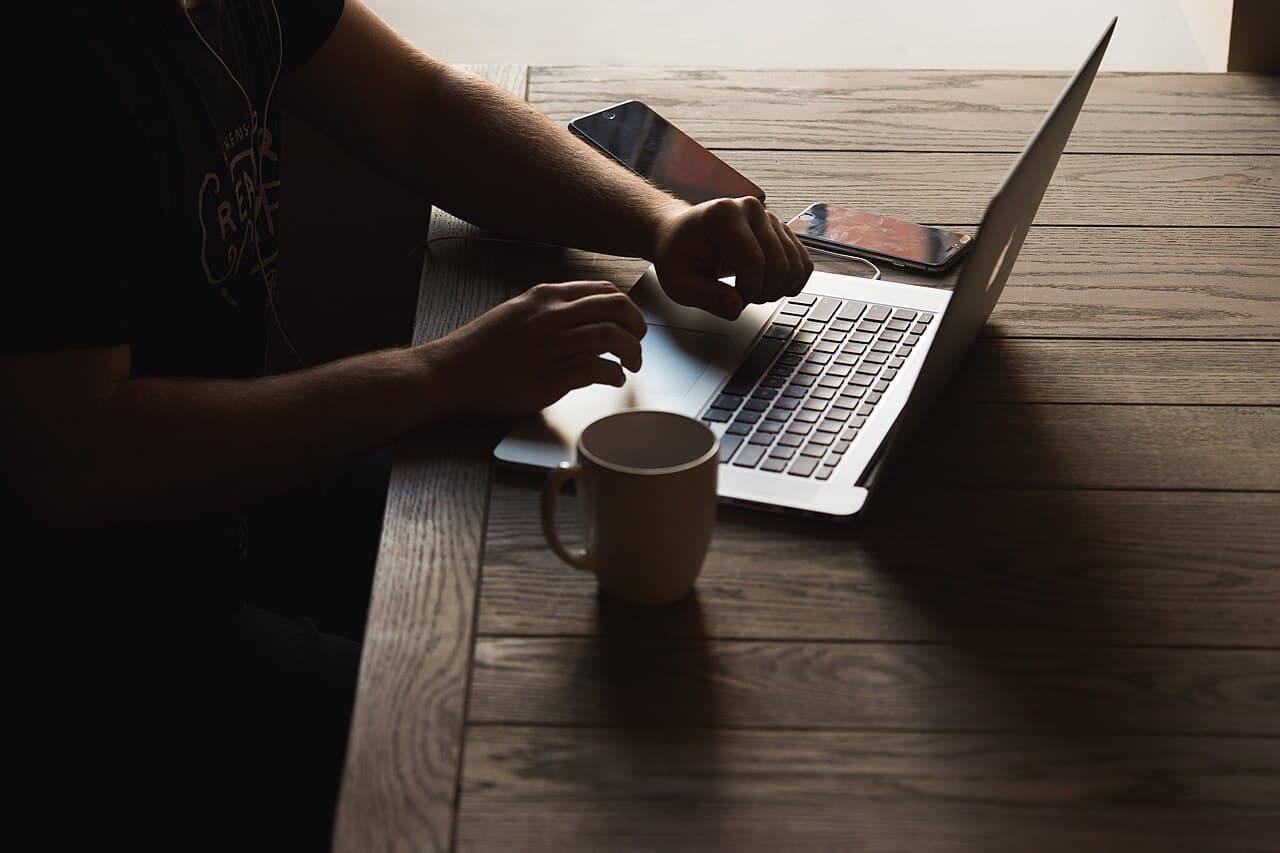 Mobile developer working with a laptop and smartphones